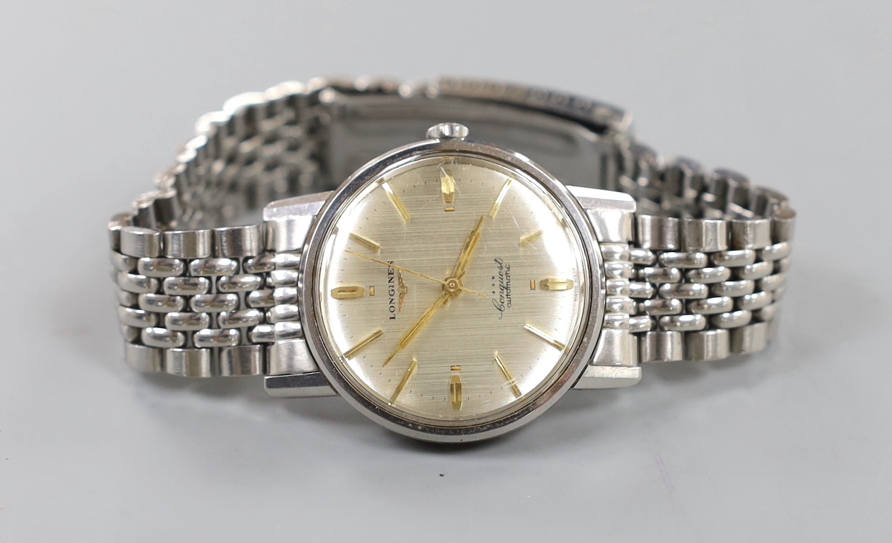 A gentleman's stainless steel Longines Conquest Automatic wrist watch, on associated bracelet.